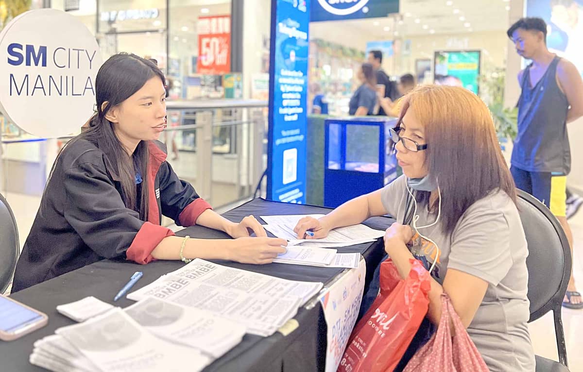 A business owner affected by the recent calamity seeks vital support at the Calamity Recovery Care Center in SM City Manila.